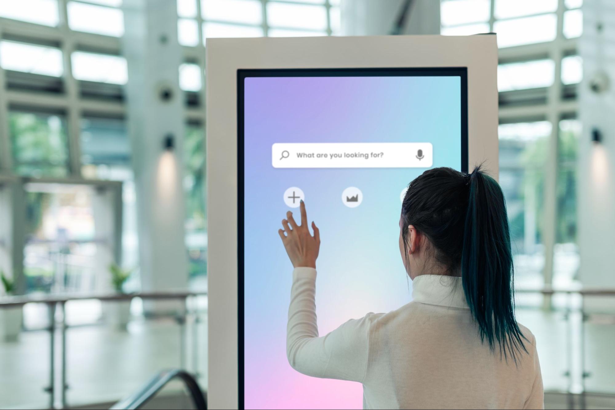 Customers interacting with AI-powered kiosks