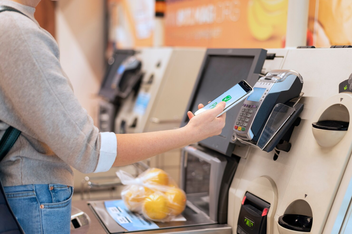 A shopper using a self-service checkout system